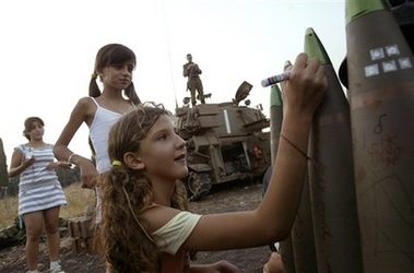 Israeli girls write messages on a shell