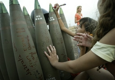 Israeli girls write messages on a shell